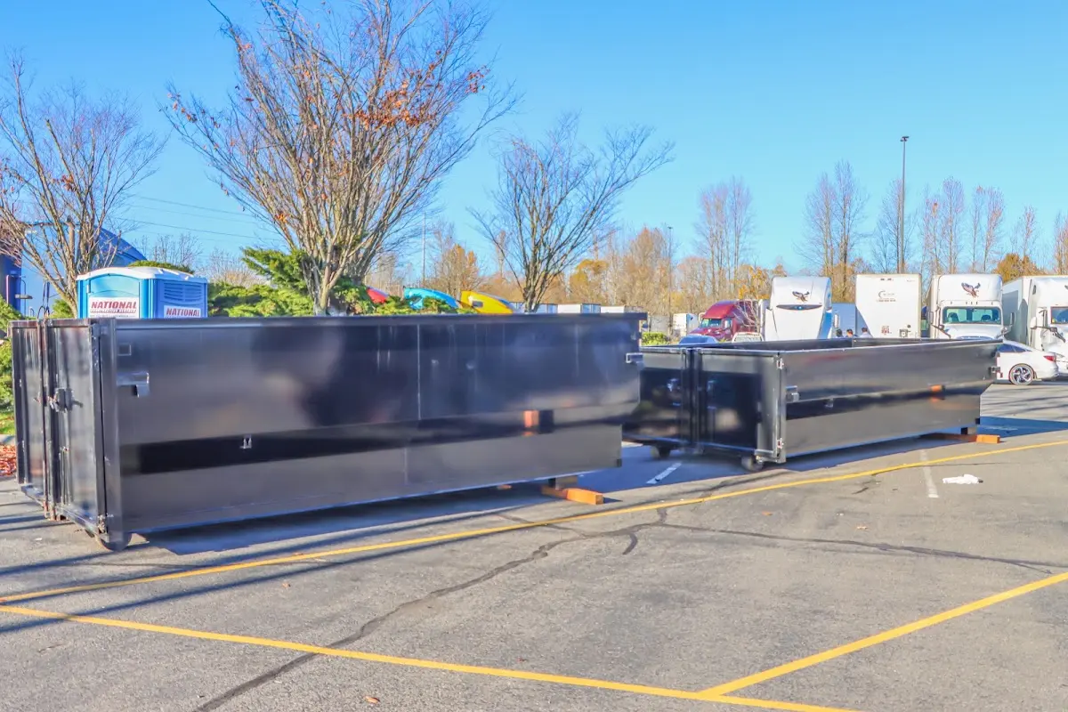 Professional dumpster rental service with roll-off container on residential driveway in Erwin